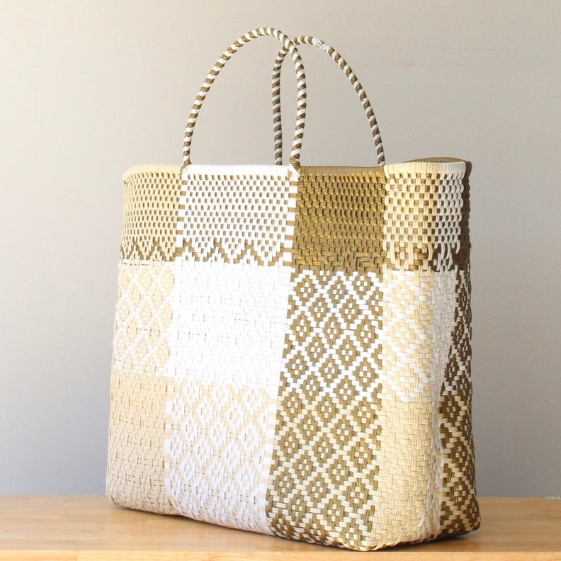 Woven basket with geometric pattern on a wooden surface