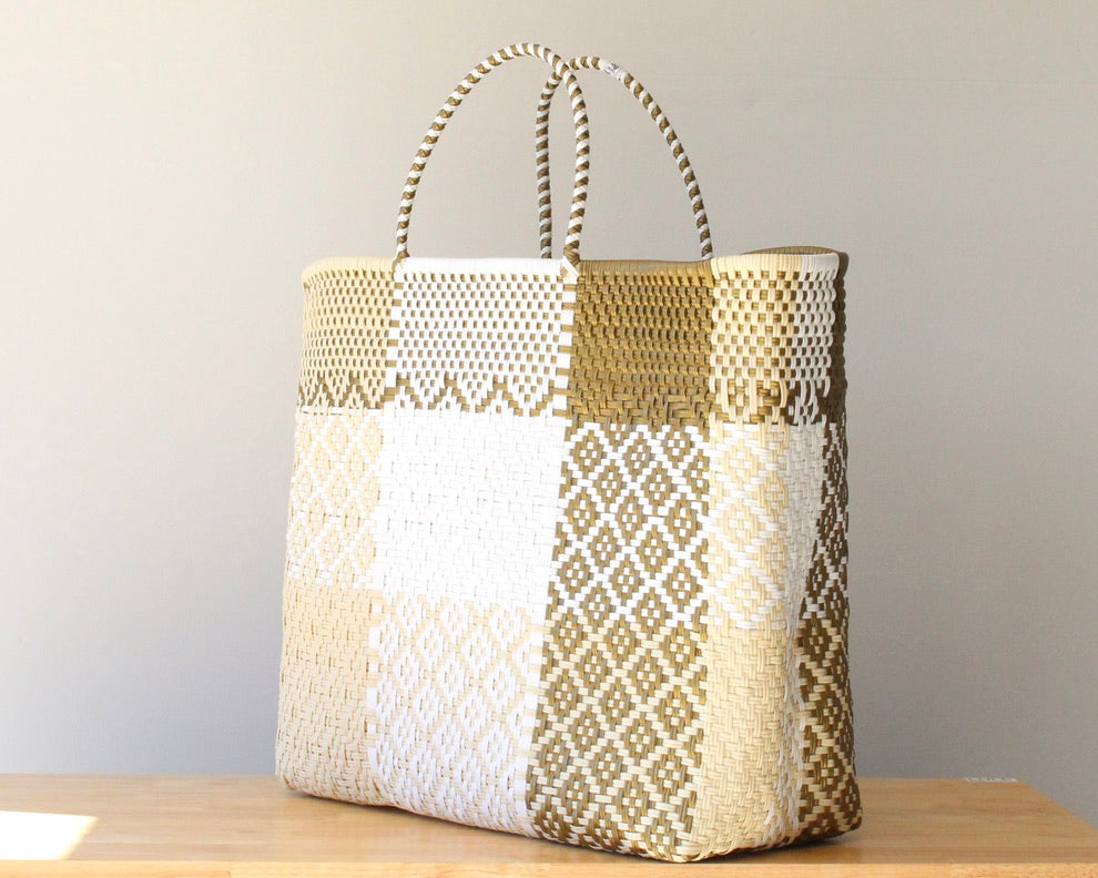 Woven basket with geometric pattern on a wooden surface