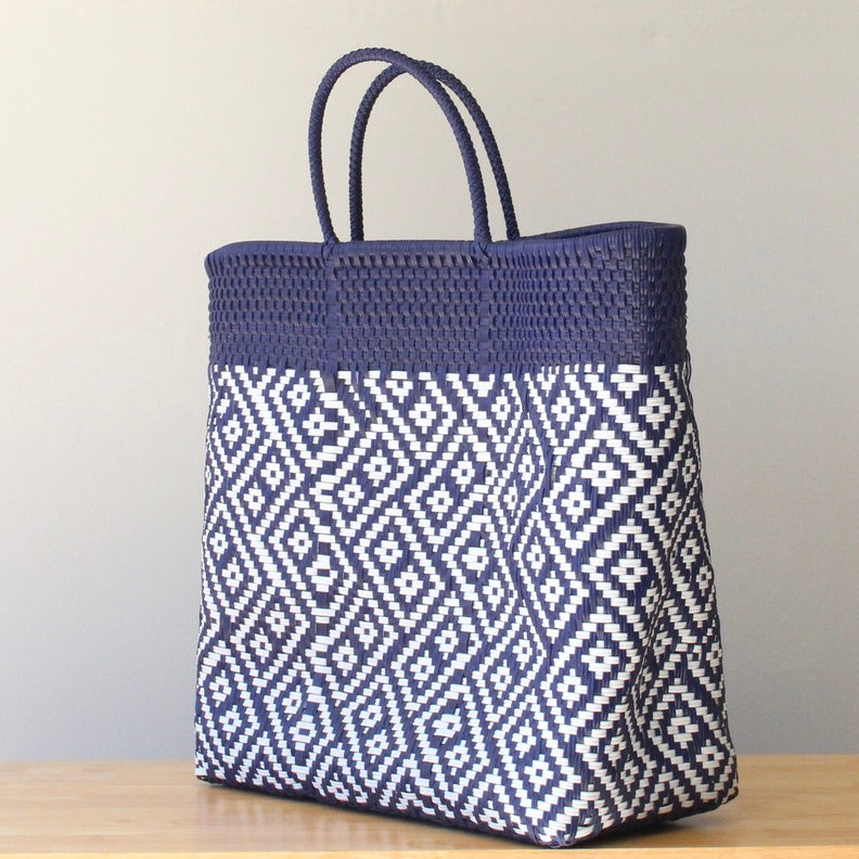 Navy blue and white patterned tote bag on a wooden surface with a neutral background