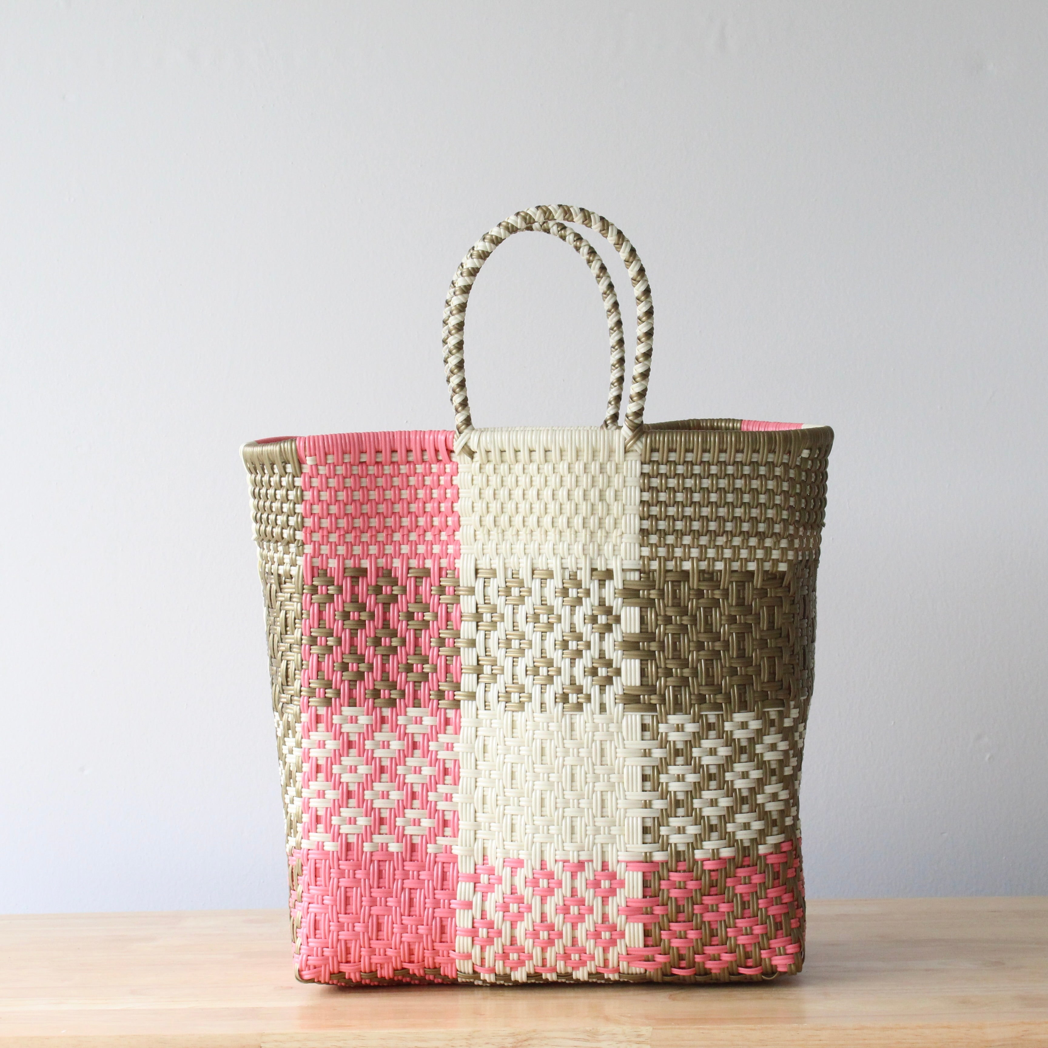 Handwoven Mexican medium tote bag in pink and neutral colors made from recycled plastic