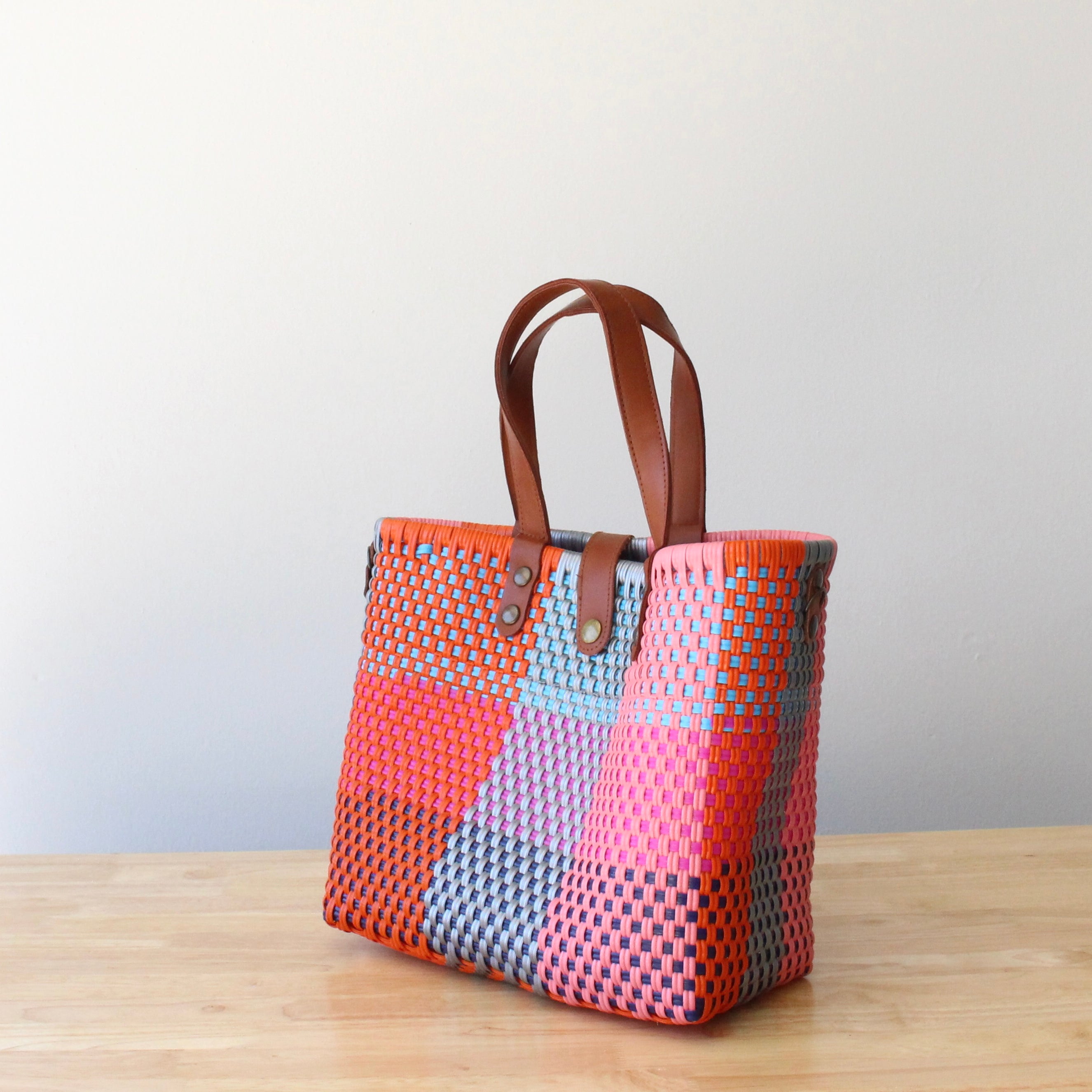 Vibrant front view of a unique MexiMexi artisan bag showcasing its eco-friendly materials and cheerful colors
