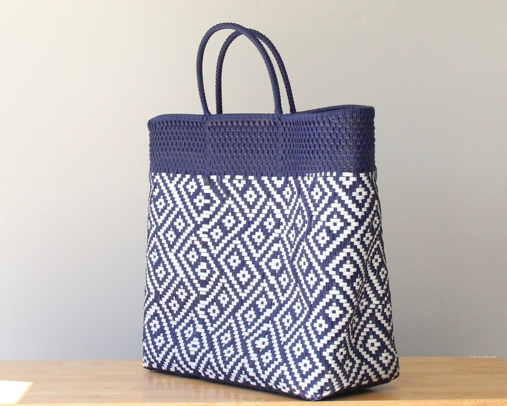 Navy blue and white patterned tote bag on a wooden surface with a neutral background