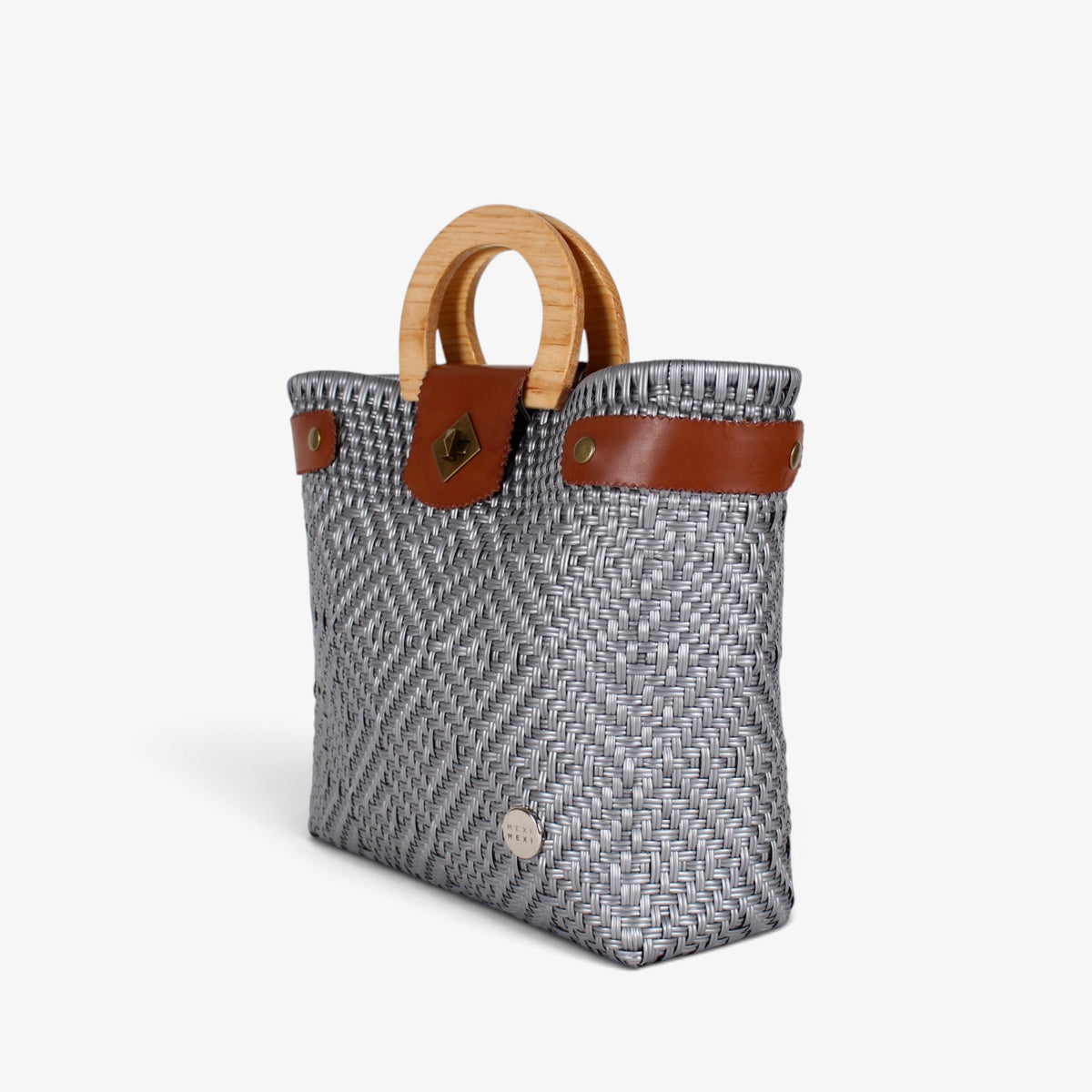 Silver gray handwoven basket bag with wood handles and brass-tone twist lock, angled view
