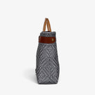 Side view of the silver gray basket bag showing its adjustable leather side strap