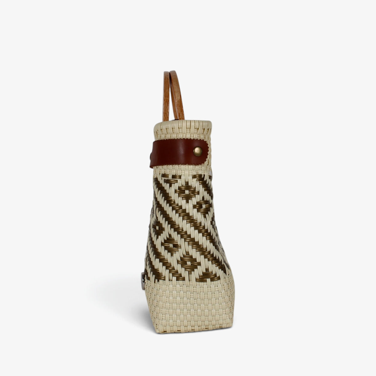 Side view of the cream and gold basket bag showing its adjustable leather side strap