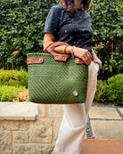 Olive green Laura Maria Mexican basket tote with brown leather handles, lifestyle photo