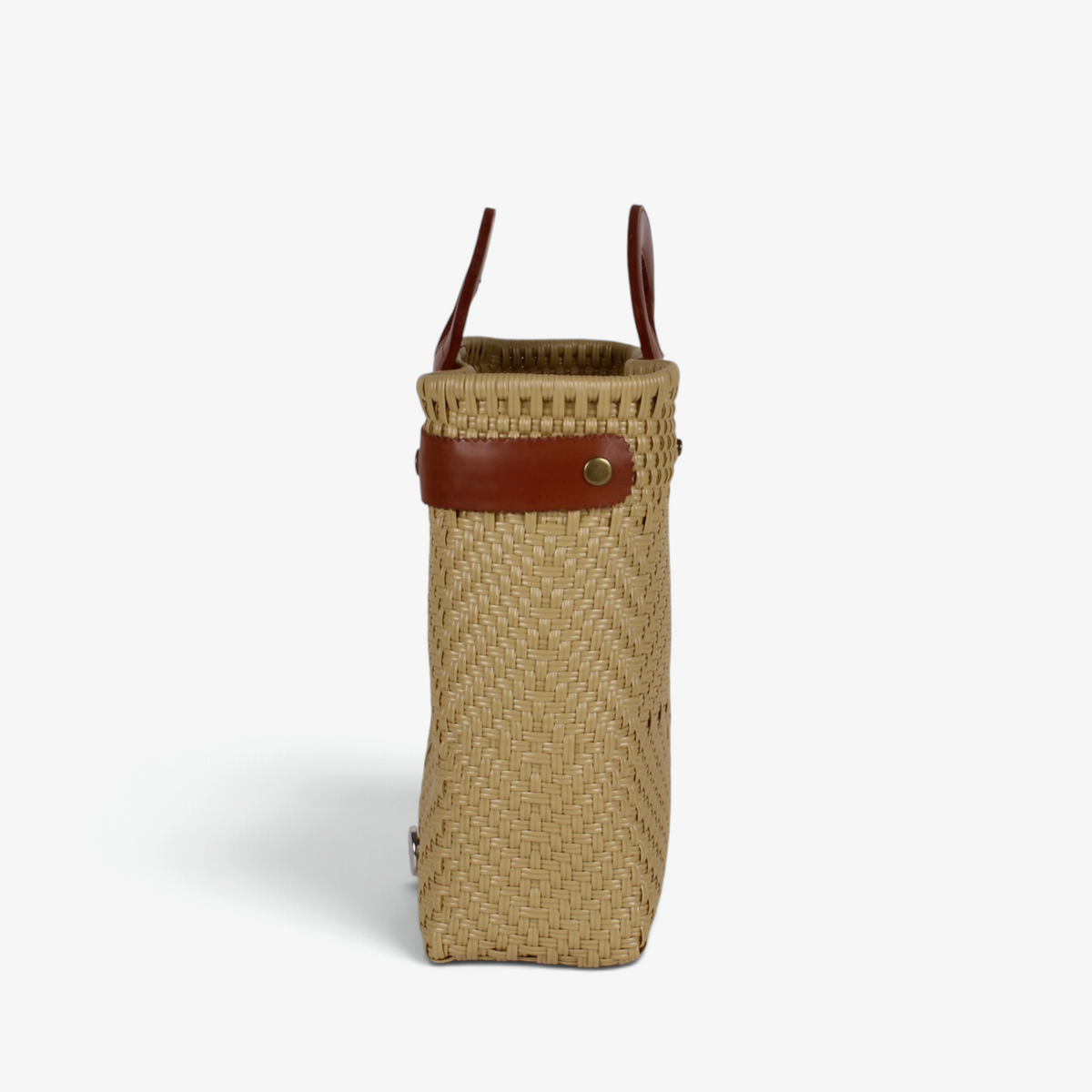 Side view of the khaki woven tote showing its adjustable leather side strap
