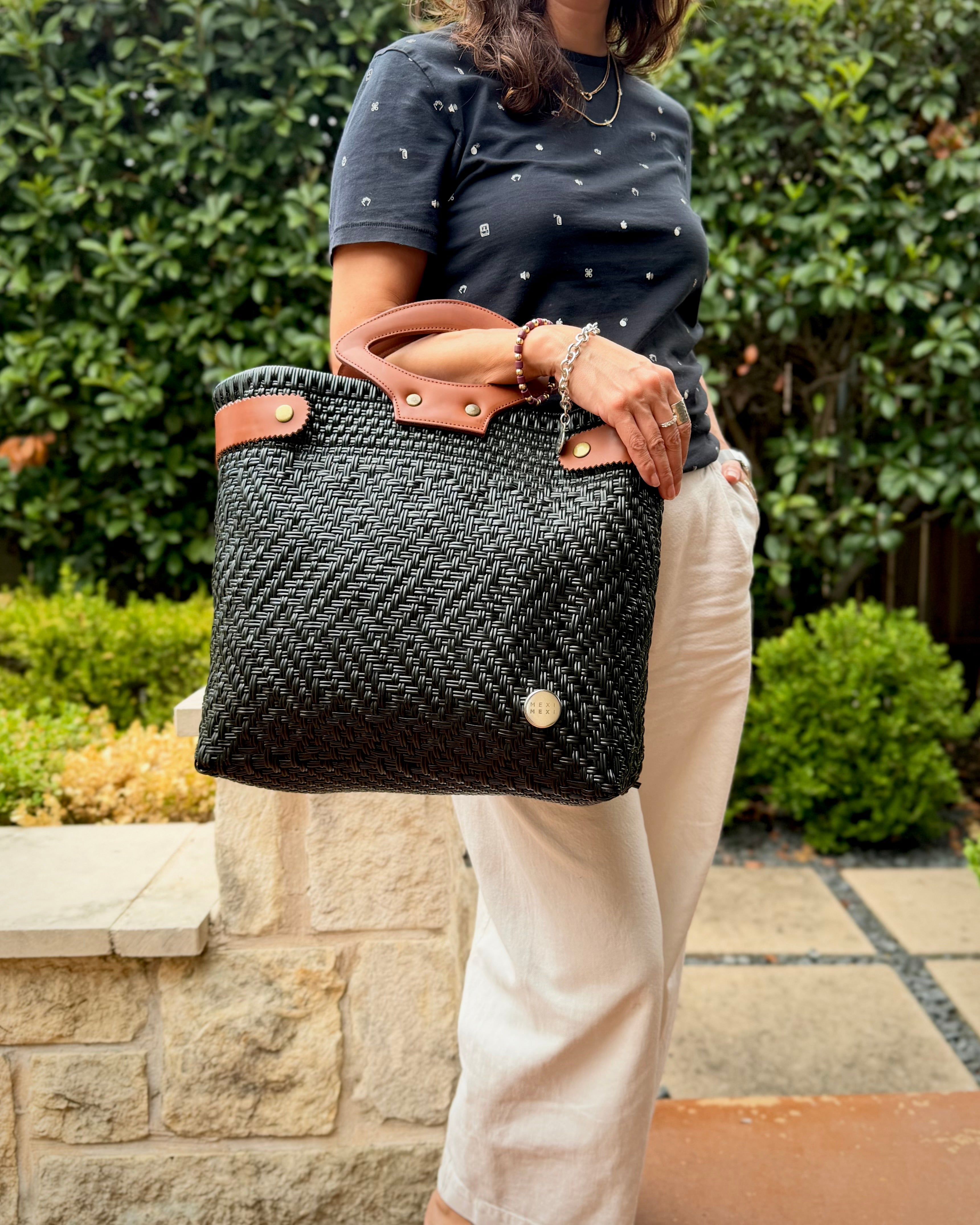 Charcoal Laura Maria Mexican basket tote with brown leather handles, lifestyle photo
