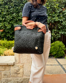 Charcoal Laura Maria Mexican basket tote with brown leather handles, lifestyle photo