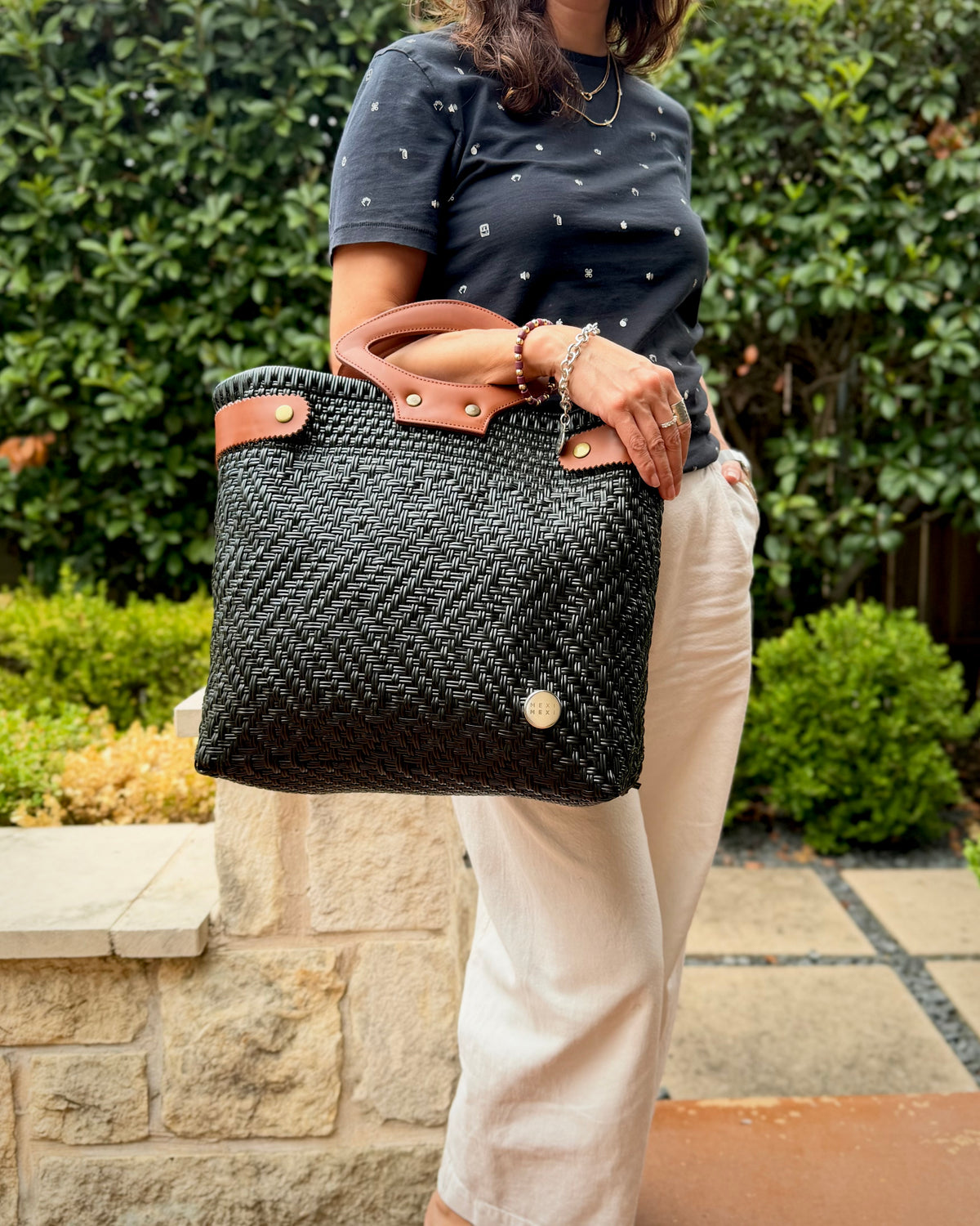 Charcoal Laura Maria Mexican basket tote with brown leather handles, lifestyle photo