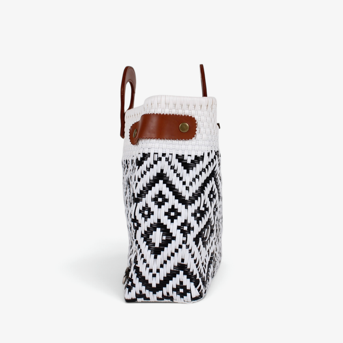 Side view of the white and black geometric tote showing its adjustable leather side strap