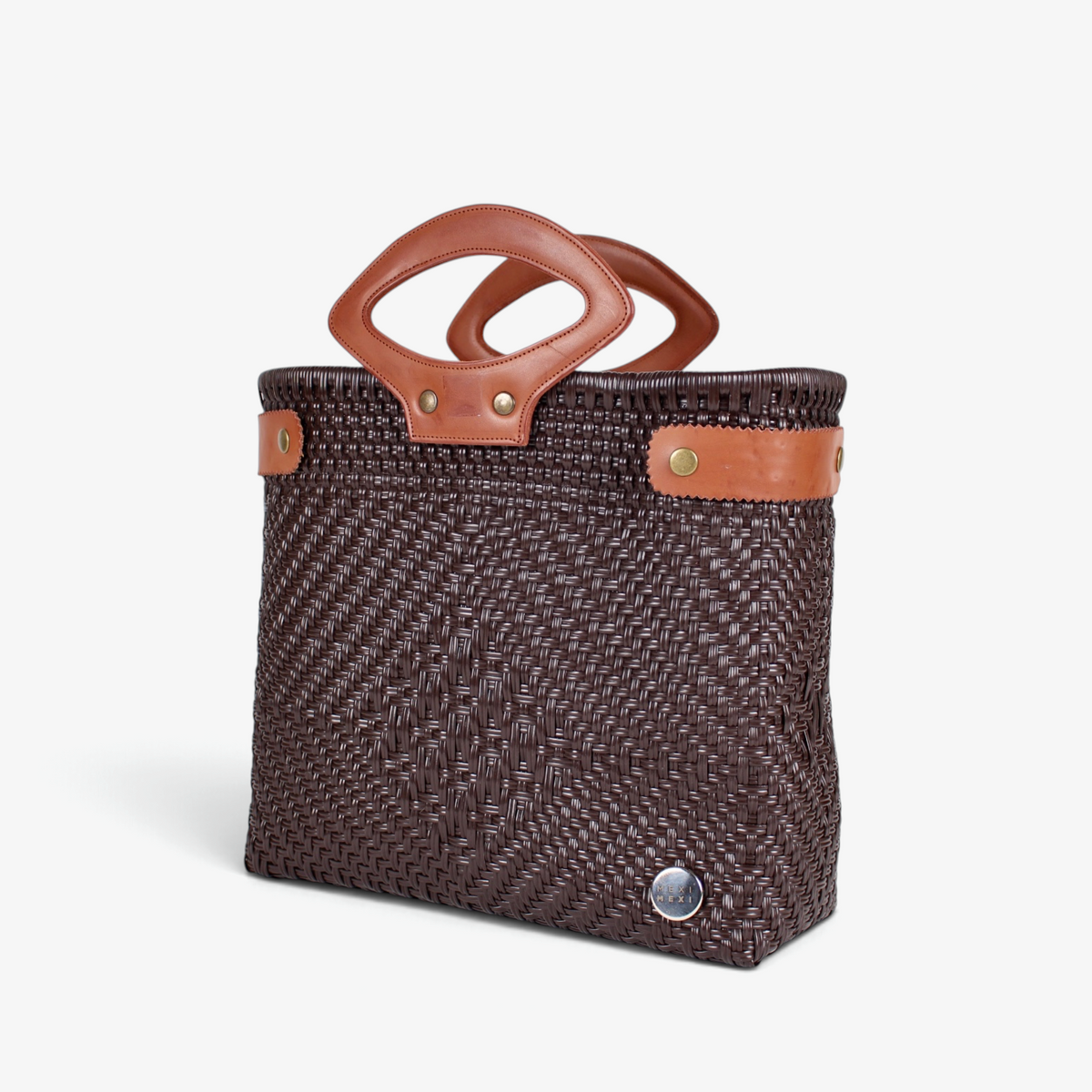 Dark brown handwoven basket bag with brown genuine leather handles and snap side straps, angled view