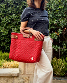 Red Laura Maria Mexican basket tote with brown leather handles, lifestyle photo