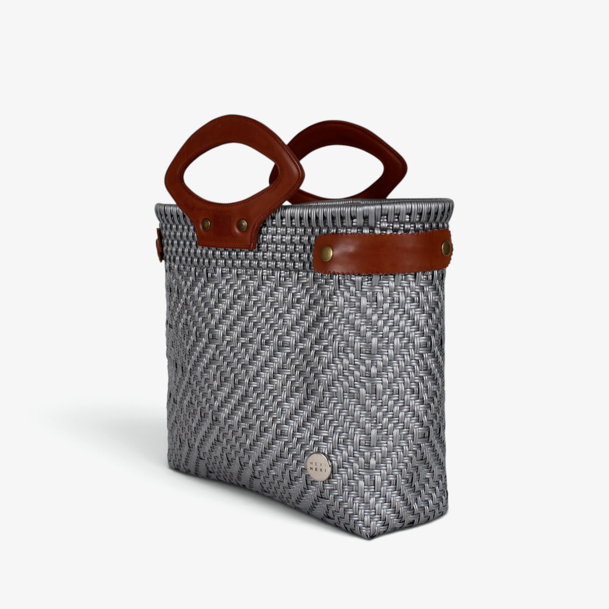 Light gray handwoven basket bag with brown genuine leather handles and snap side straps, angled view