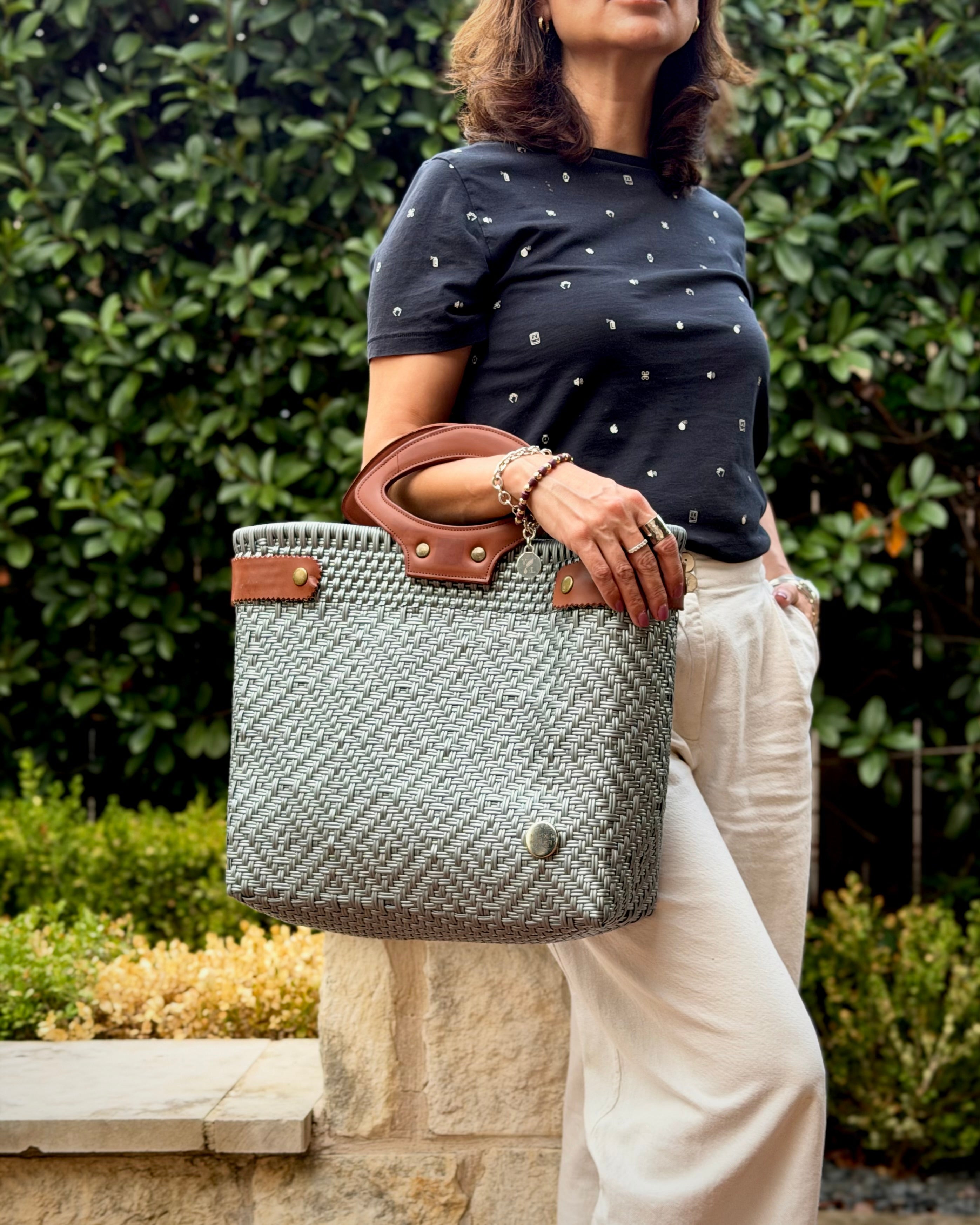 Gray Laura Maria Mexican basket tote with brown leather handles, lifestyle photo