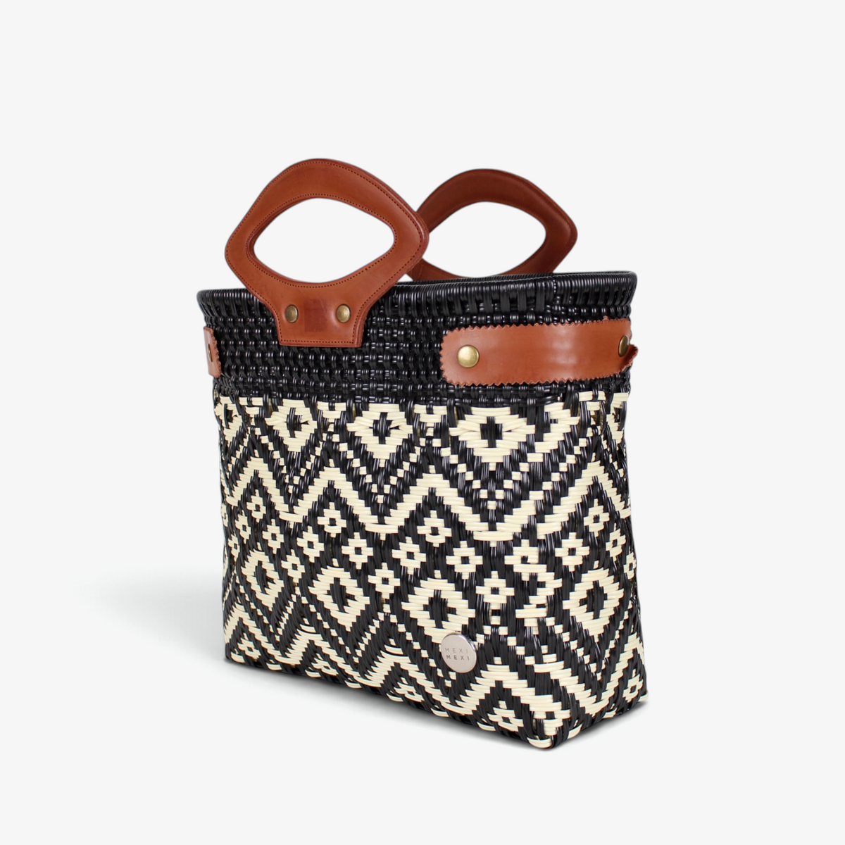 Black and ivory diamond-pattern woven tote with brown genuine leather handles, angled view