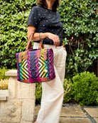 Pink & Purple Theresa Mexican handbag with brown leather handles, lifestyle photo