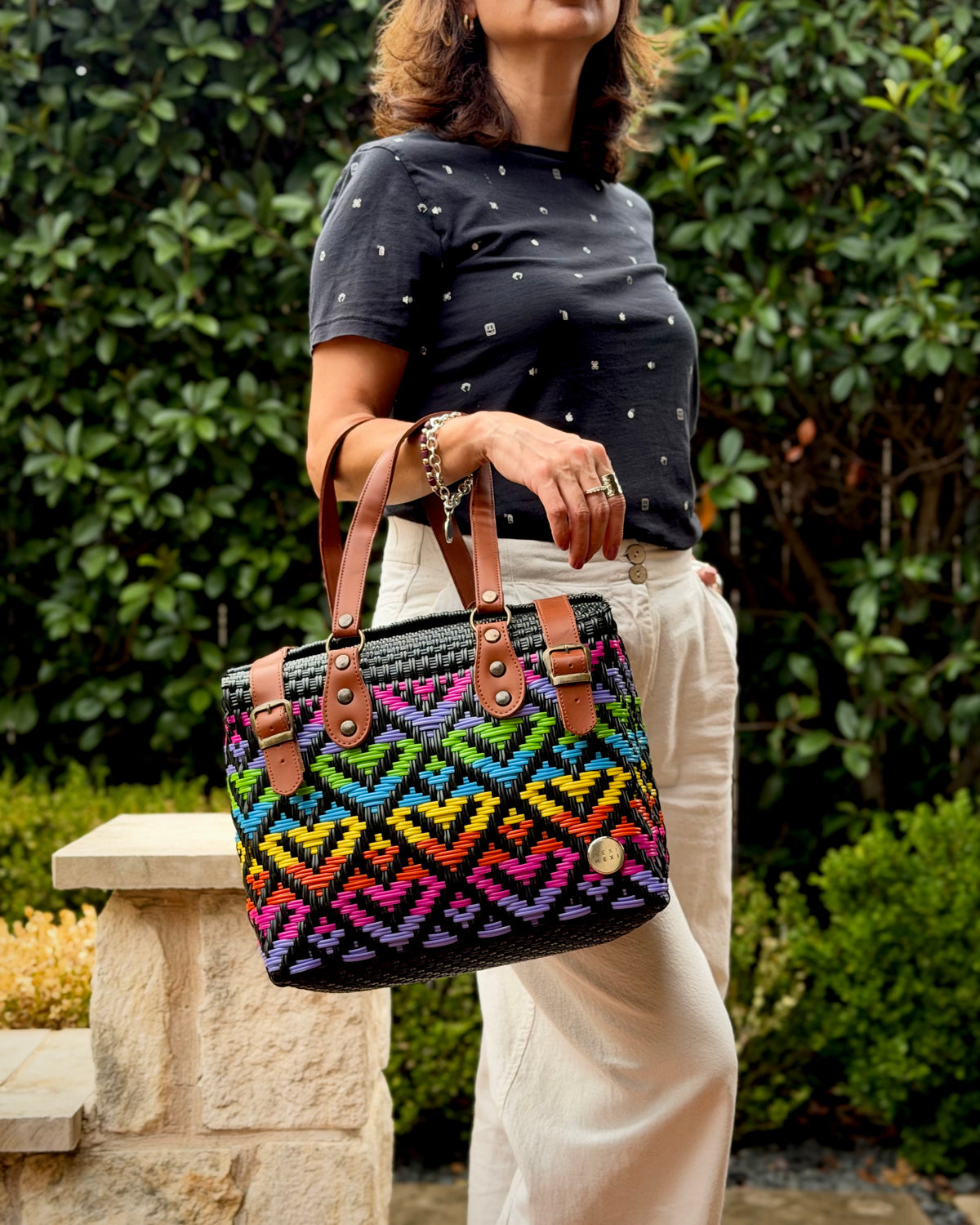 Rainbow Theresa Mexican handbag with brown leather handles, lifestyle photo