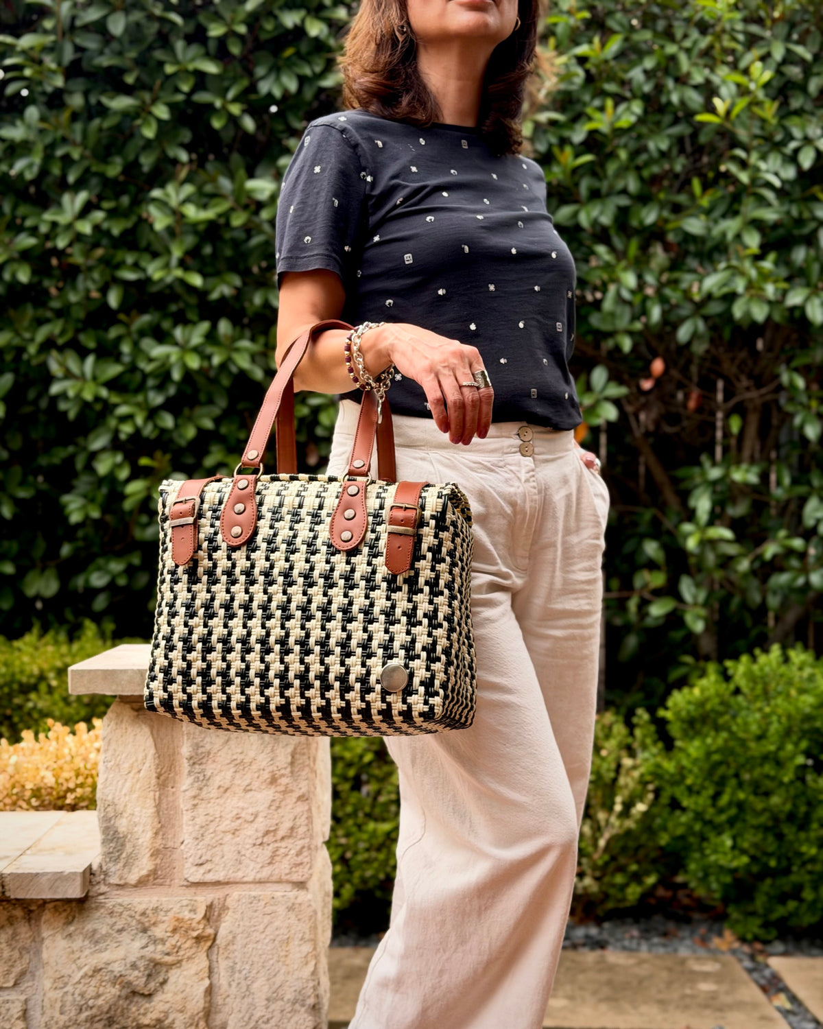 Black & Cream Houndstooth Theresa Mexican handbag with brown leather handles, lifestyle photo