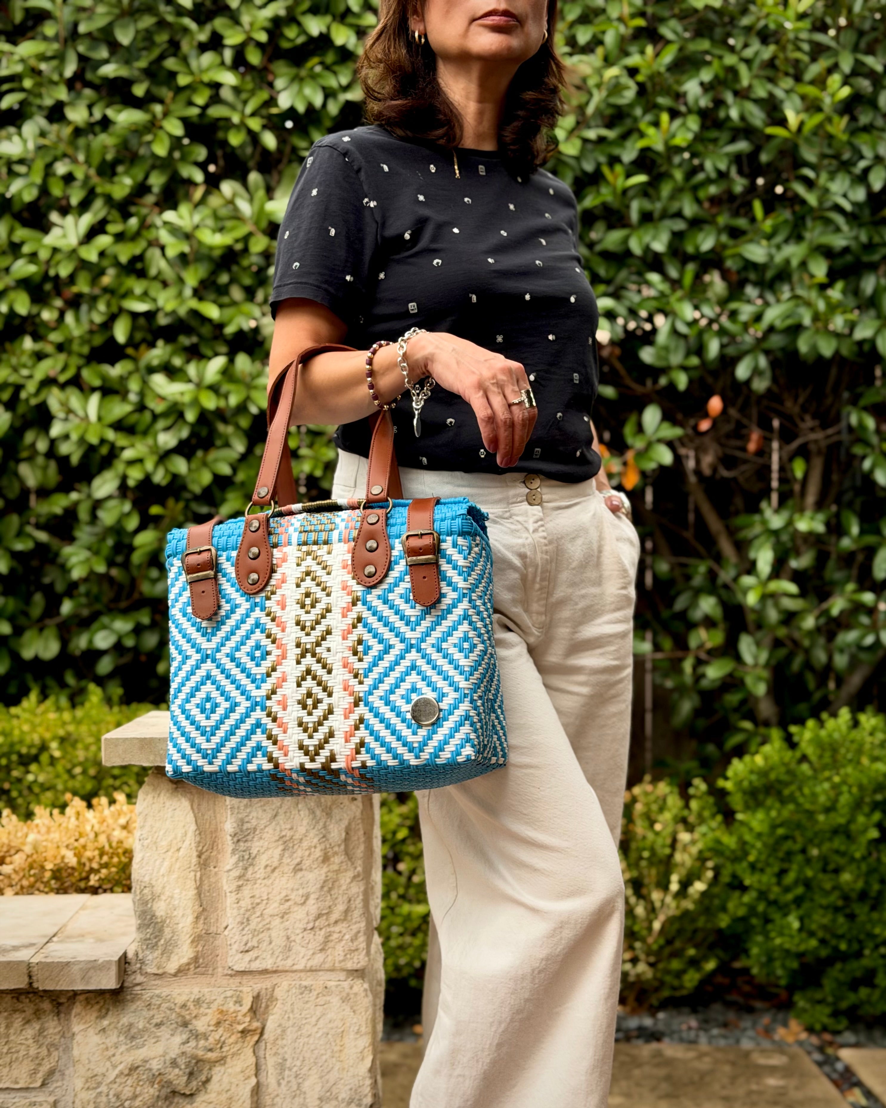 Light Blue Theresa Mexican handbag with brown leather handles, lifestyle photo