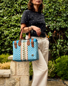 Light Blue Theresa Mexican handbag with brown leather handles, lifestyle photo
