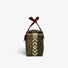 Side view of the forest green woven handbag with leather flap and snap closure