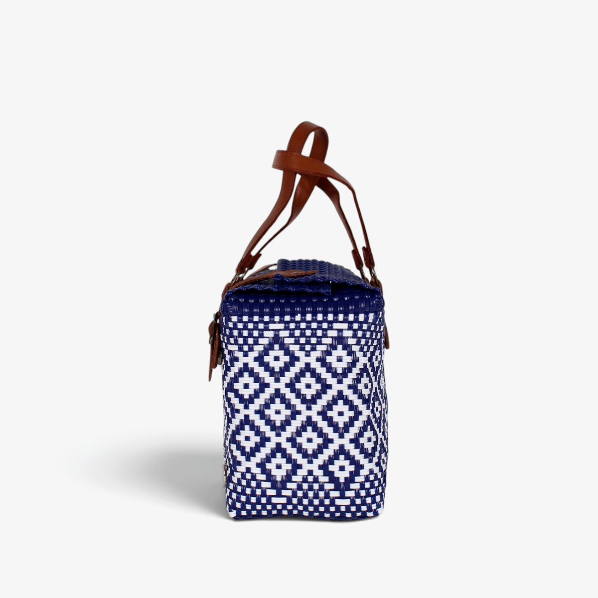Side view of the navy and white woven handbag with leather flap and snap closure