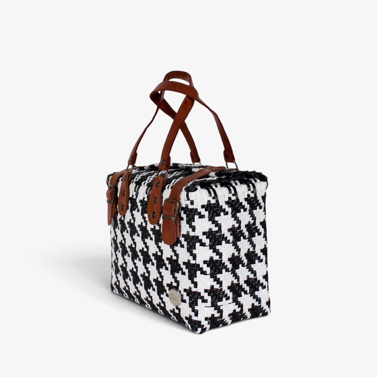 Black and white houndstooth handwoven handbag with brown genuine leather handles and brass-tone hardware, angled view