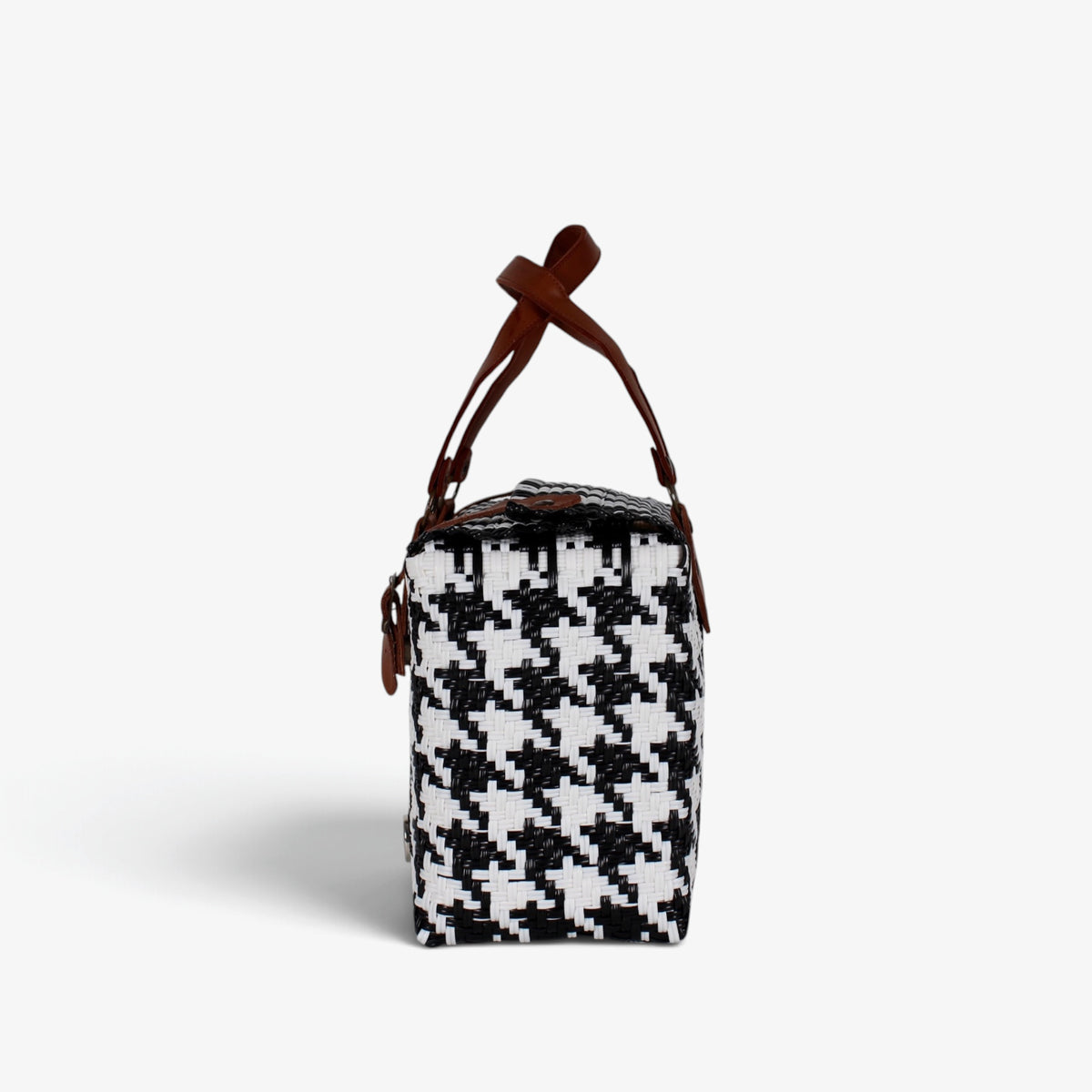 Side view of the black and white houndstooth woven handbag with leather flap and snap closure