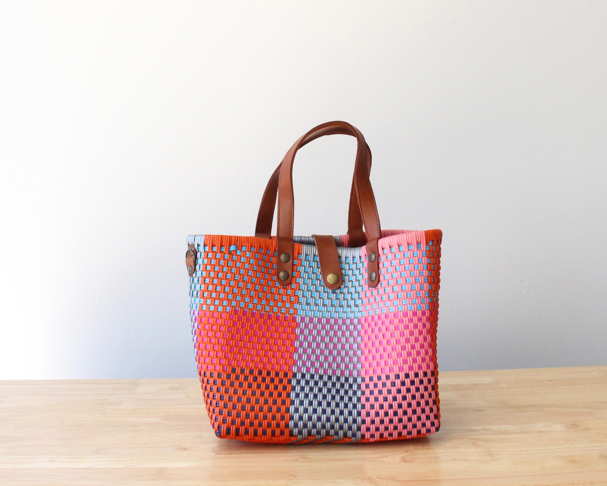 Colorful handmade MexiMexi artisan bag with fun patterns and leather handles, perfect for all occasions