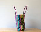 Diagonal view of rainbow woven Mexican tote — waterproof artisan bag by MexiMexi