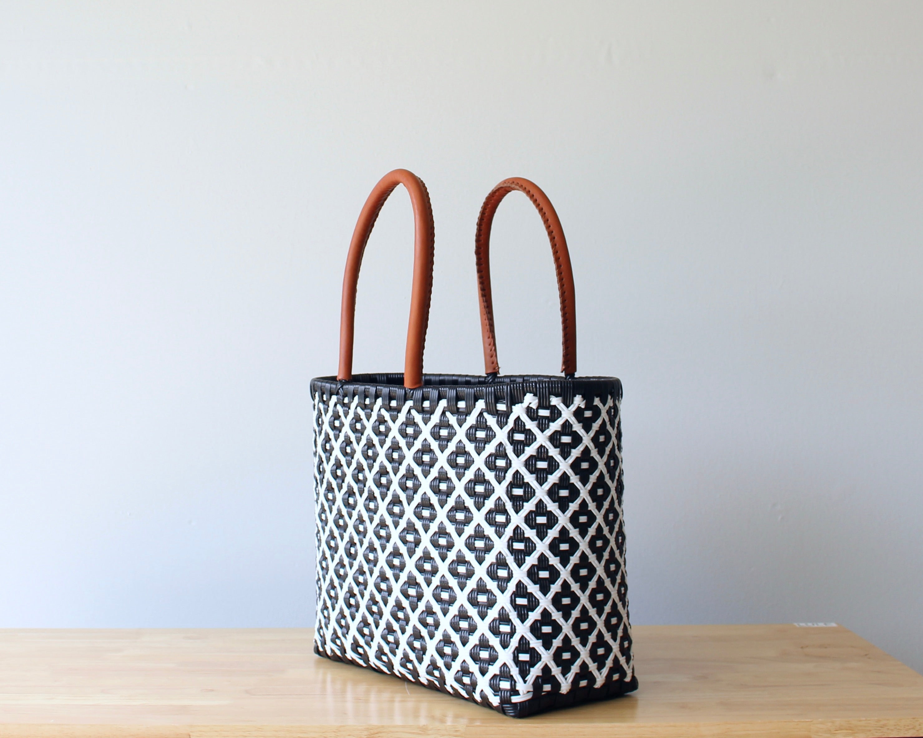 Diagonal view of navy and white geometric woven tote — waterproof artisan bag by MexiMexi