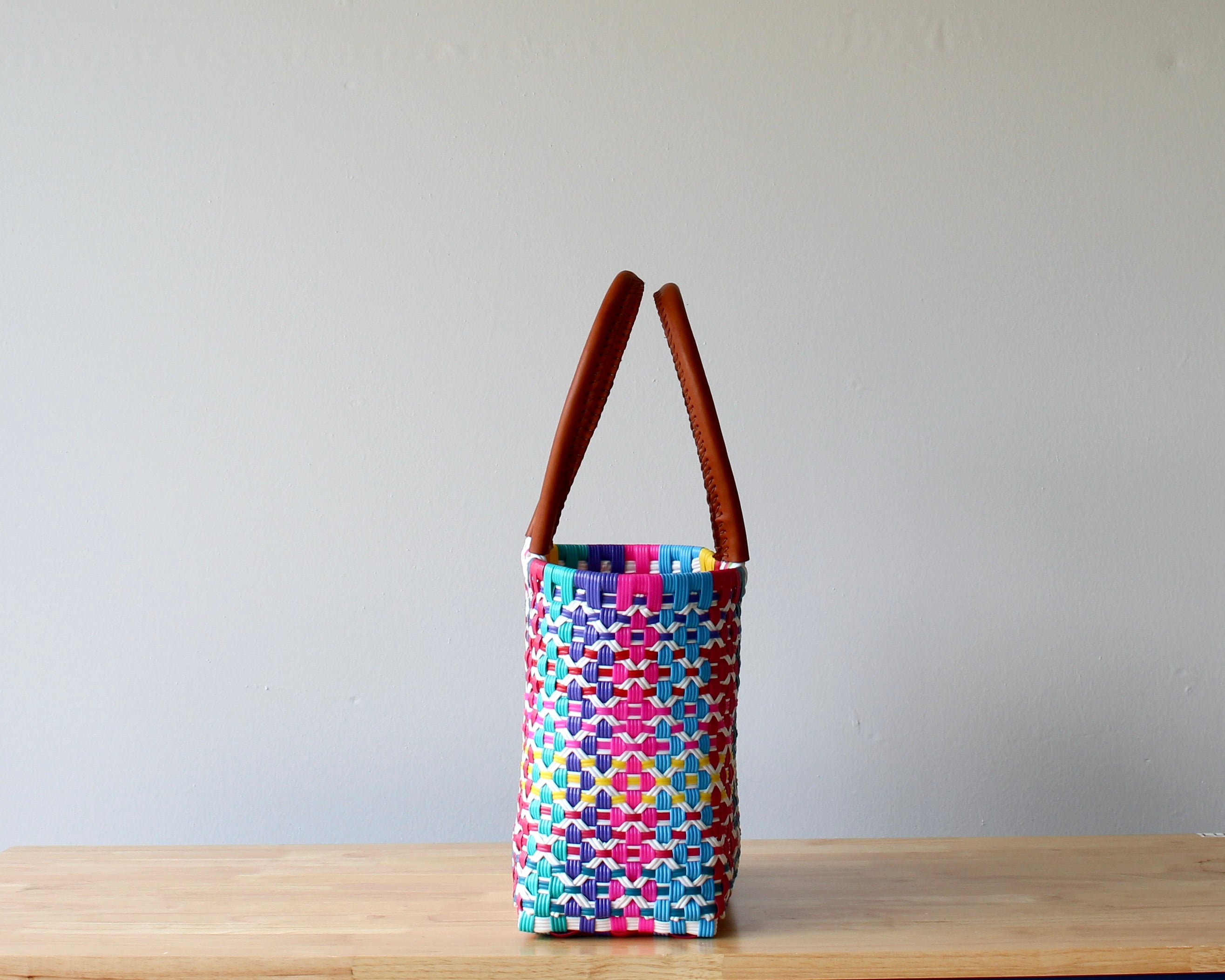 Side view of pink multicolor handwoven Mexican tote — one-of-a-kind artisan bag by MexiMexi