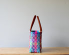 Side view of pink multicolor handwoven Mexican tote — one-of-a-kind artisan bag by MexiMexi