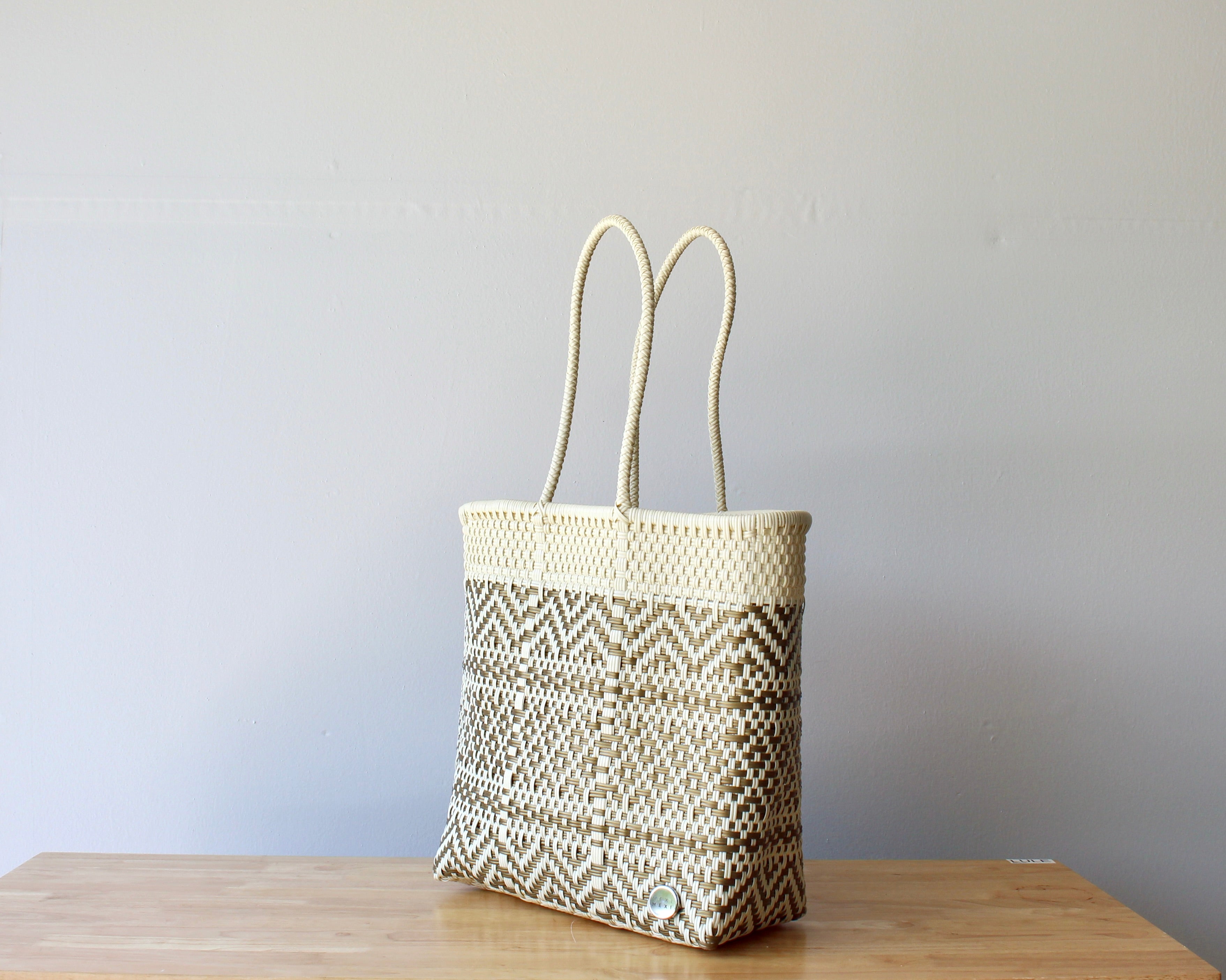Diagonal view of neutral beige woven Mexican tote — waterproof artisan bag by MexiMexi