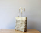 Diagonal view of neutral beige woven Mexican tote — waterproof artisan bag by MexiMexi