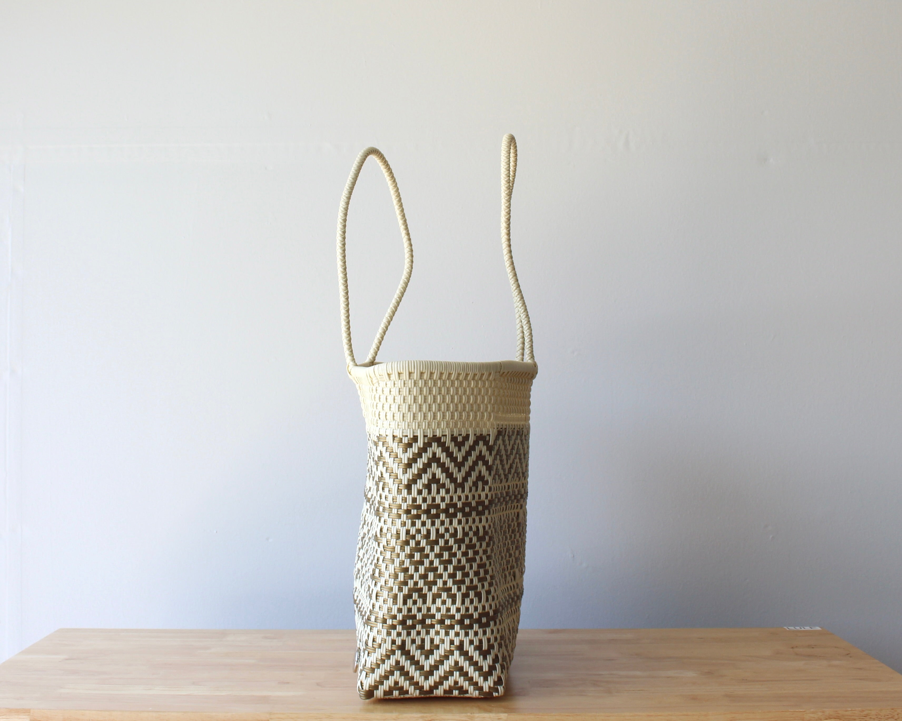 Side view of cream natural handwoven Mexican tote — one-of-a-kind artisan bag by MexiMexi
