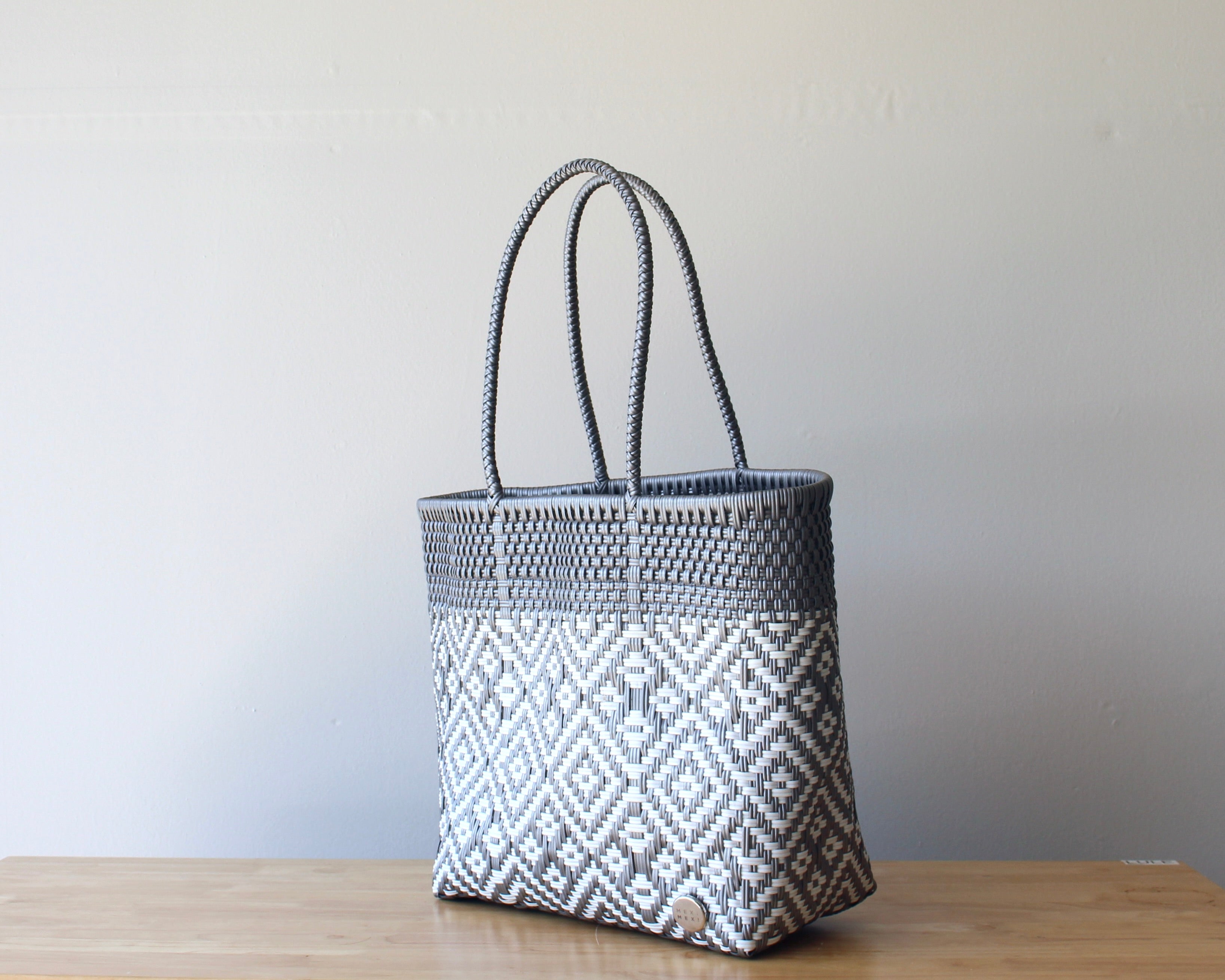 Diagonal view of smoke gray woven tote bag — waterproof artisan bag by MexiMexi