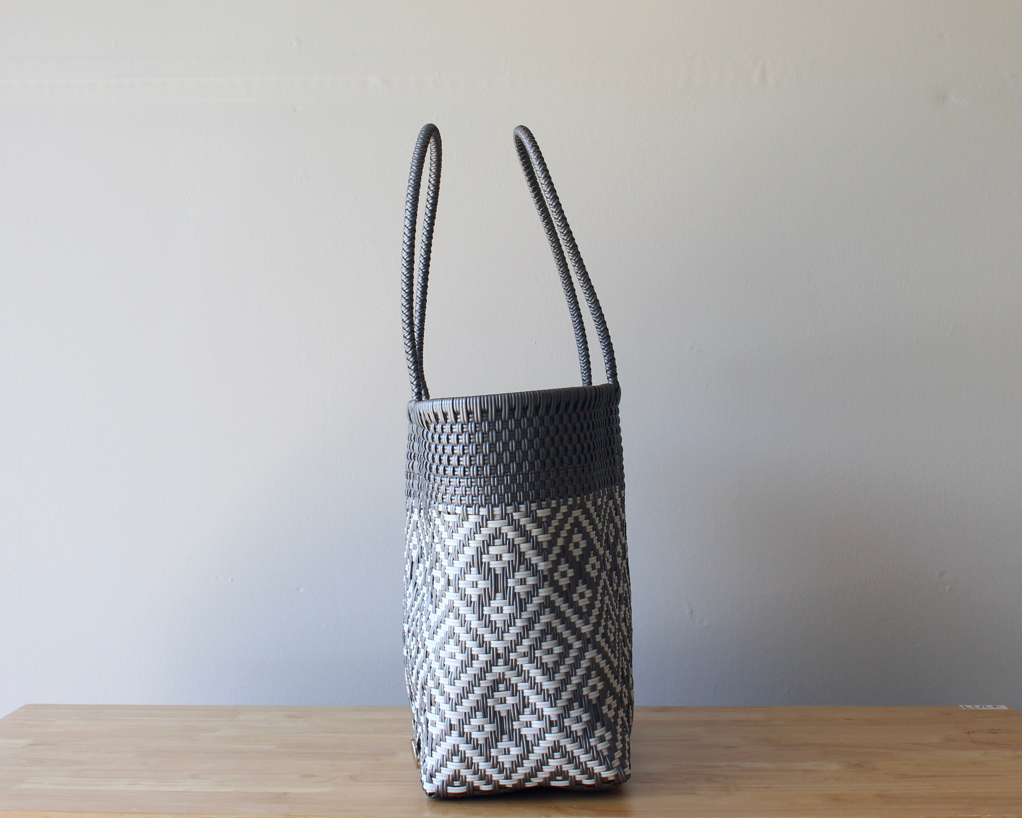 Side view of gray geometric handwoven Mexican tote — one-of-a-kind artisan bag by MexiMexi