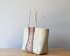 Diagonal view of the beige and rose woven artisan tote — waterproof Mexican bag by MexiMexi