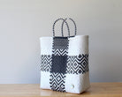 Diagonal view of classic black and white woven tote — waterproof artisan bag by MexiMexi