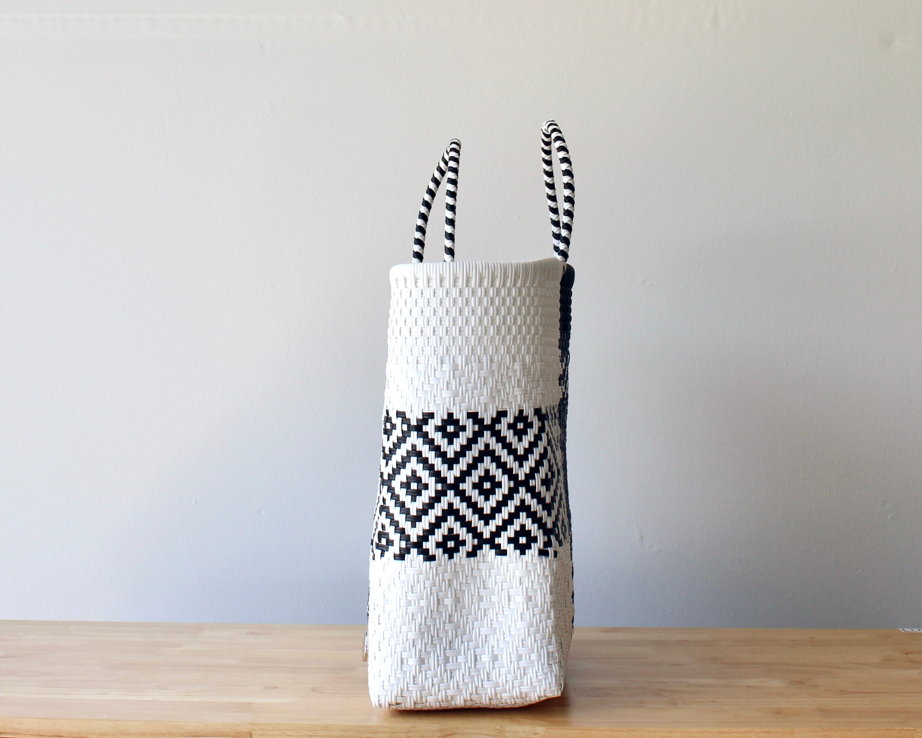 Side view of black and white check handwoven Mexican tote — one-of-a-kind artisan bag by MexiMexi