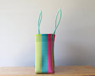 Side view of colorful striped handwoven Mexican tote — one-of-a-kind artisan bag by MexiMexi