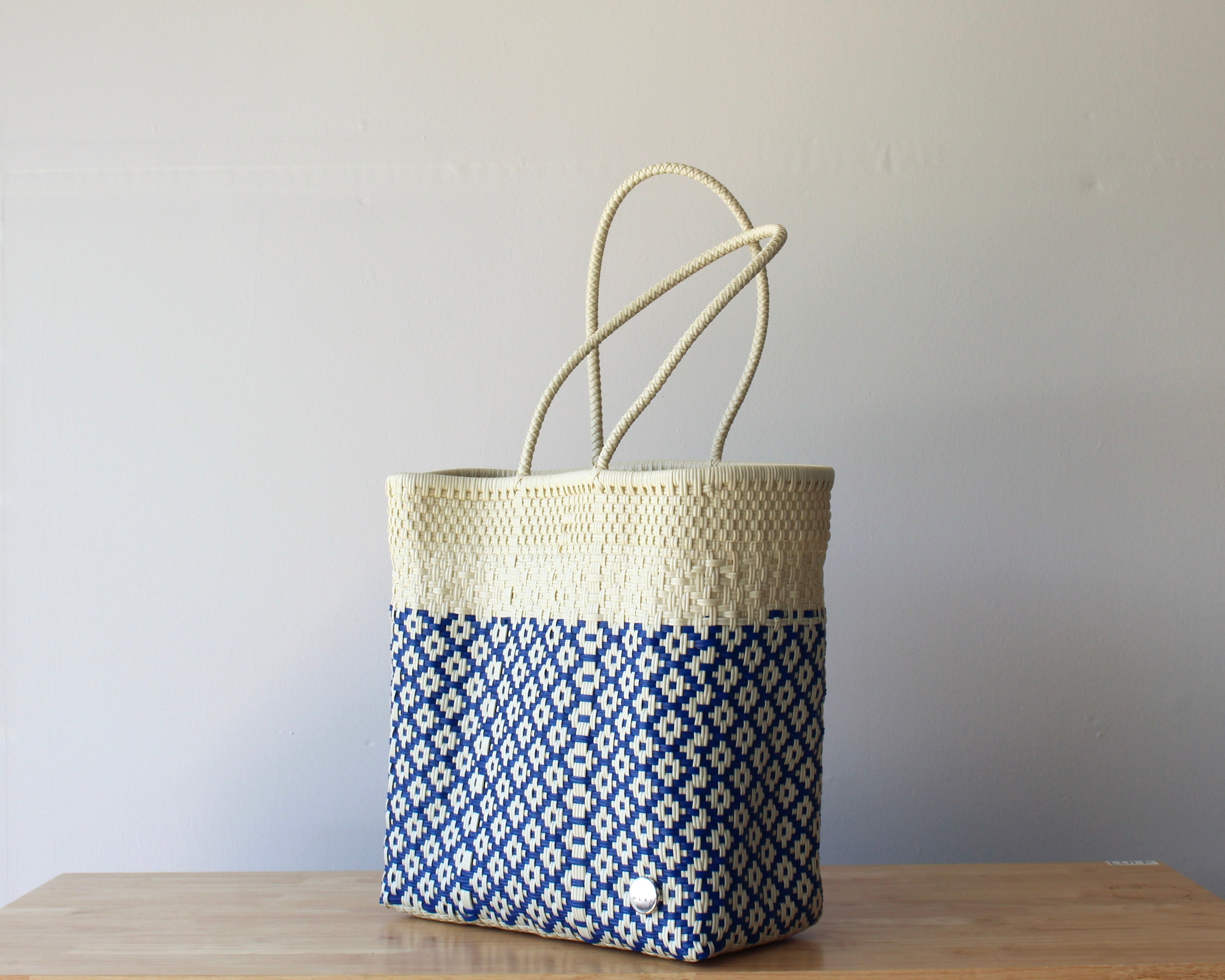 Diagonal view of two-tone woven artisan tote in ivory and blue— waterproof MexiMexi bag