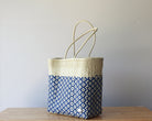 Diagonal view of two-tone woven artisan tote in ivory and blue— waterproof MexiMexi bag