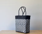 Diagonal view of black and white two-tone woven tote — waterproof artisan bag by MexiMexi