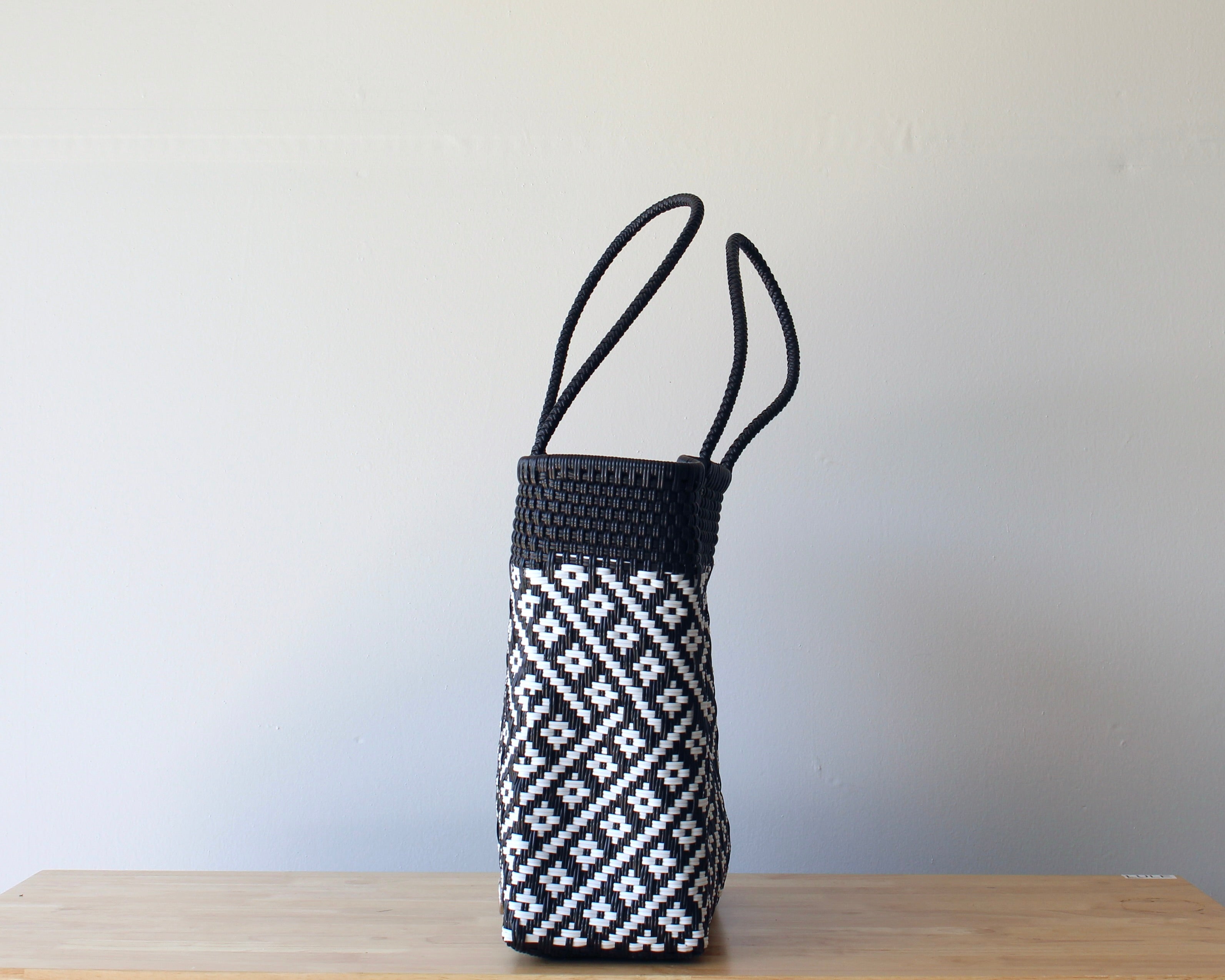 Side view of two-tone handwoven Mexican tote — one-of-a-kind artisan bag by MexiMexi