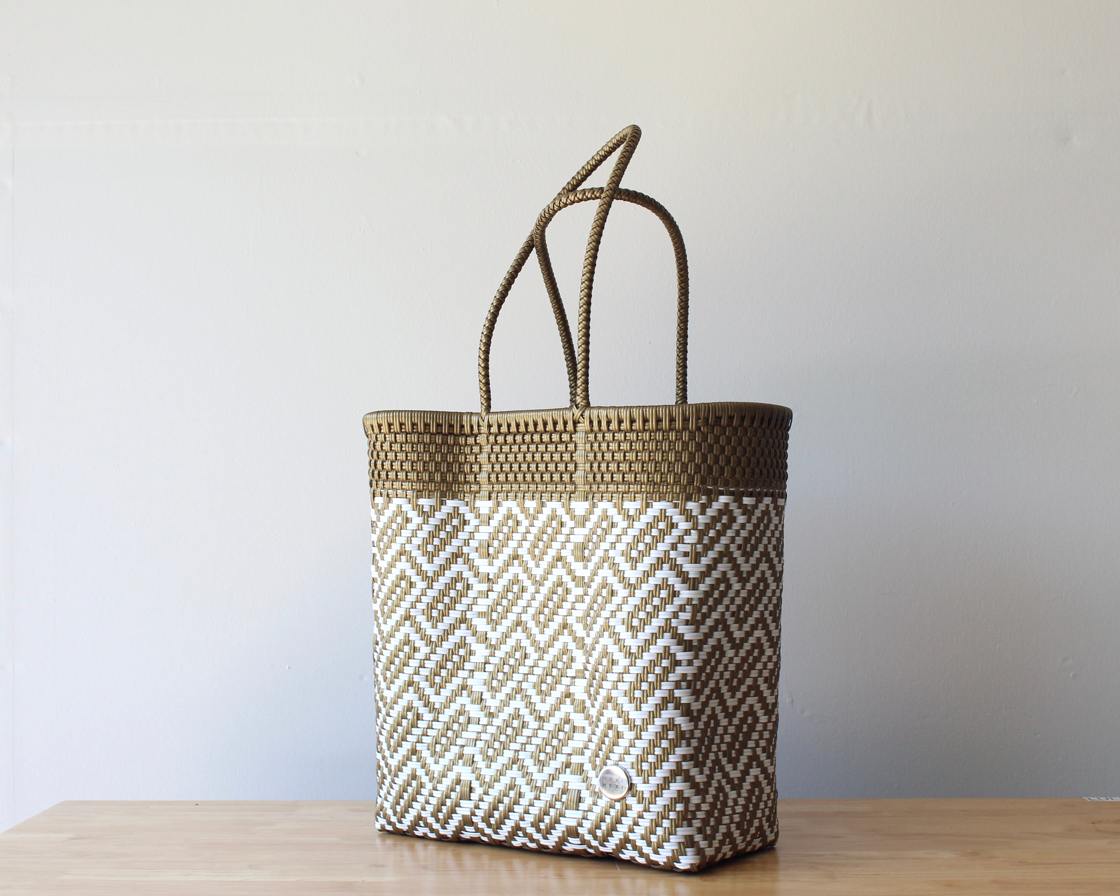 Diagonal view of the gold and white two-tone woven tote — waterproof artisan bag by MexiMexi