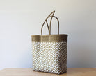 Diagonal view of the gold and white two-tone woven tote — waterproof artisan bag by MexiMexi