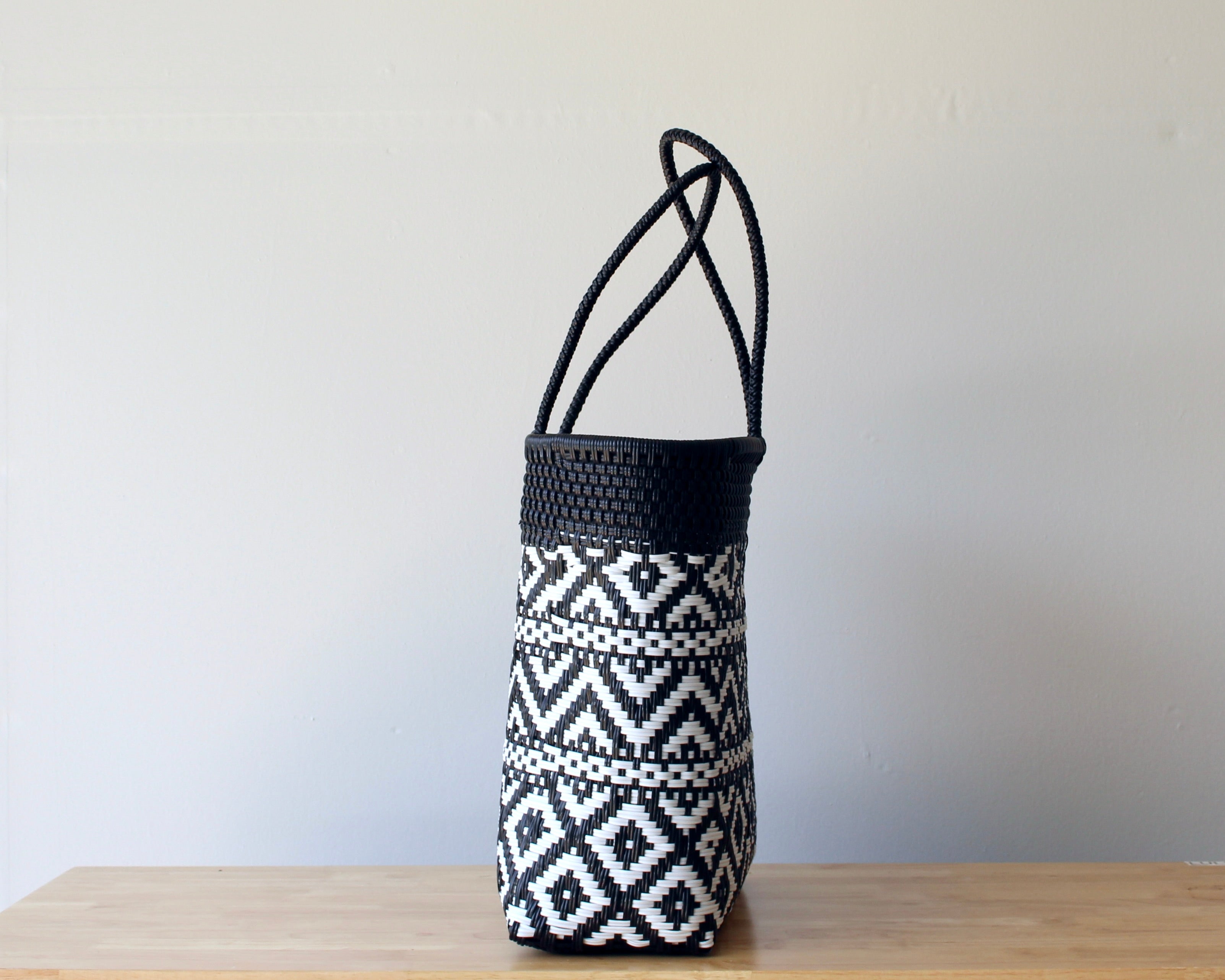 Side view of black and white handwoven Mexican tote — one-of-a-kind artisan bag by MexiMexi
